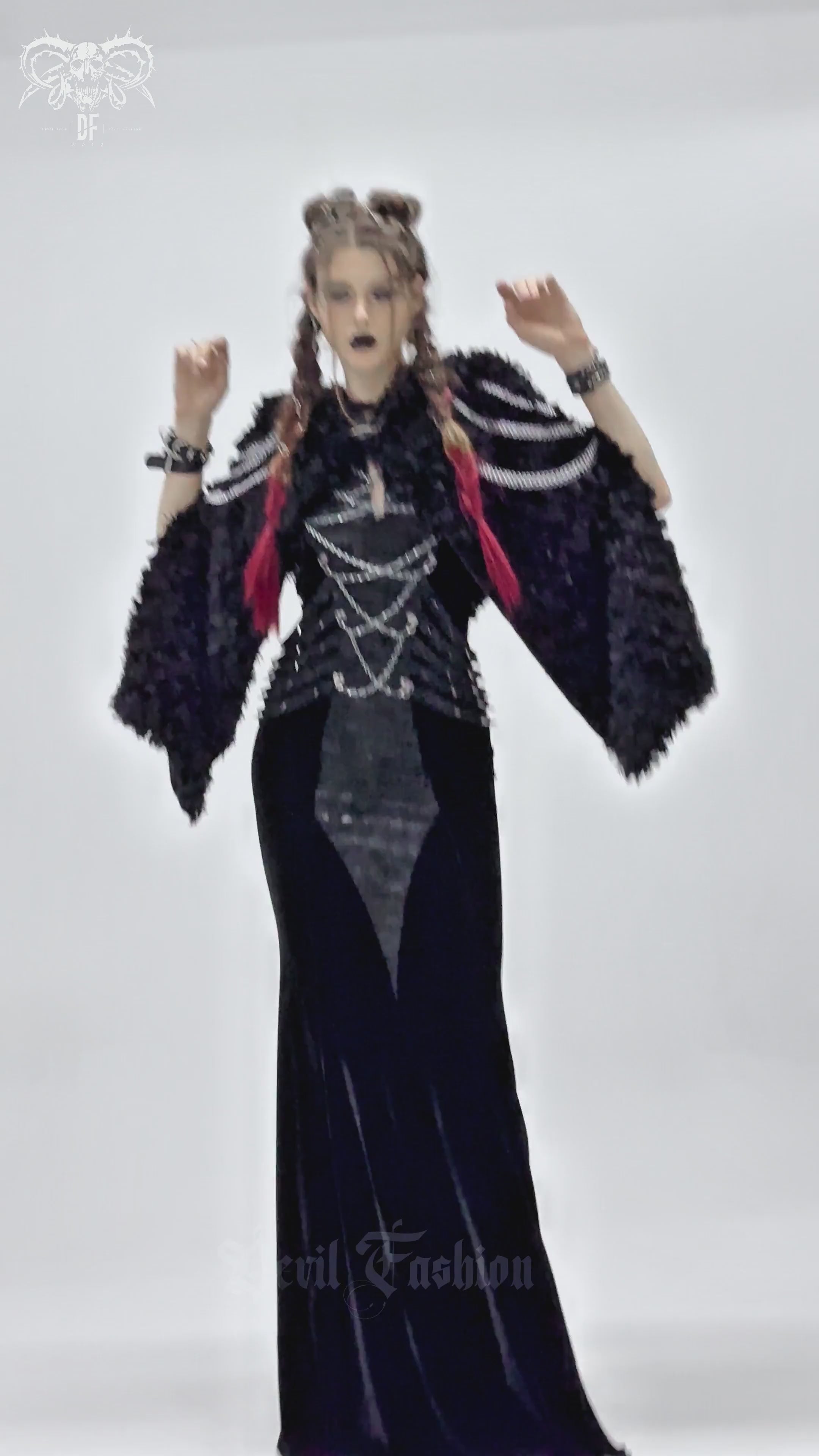 Gothic women's hooded cape with chains, paired with a dark velvet dress for a festival-ready look.