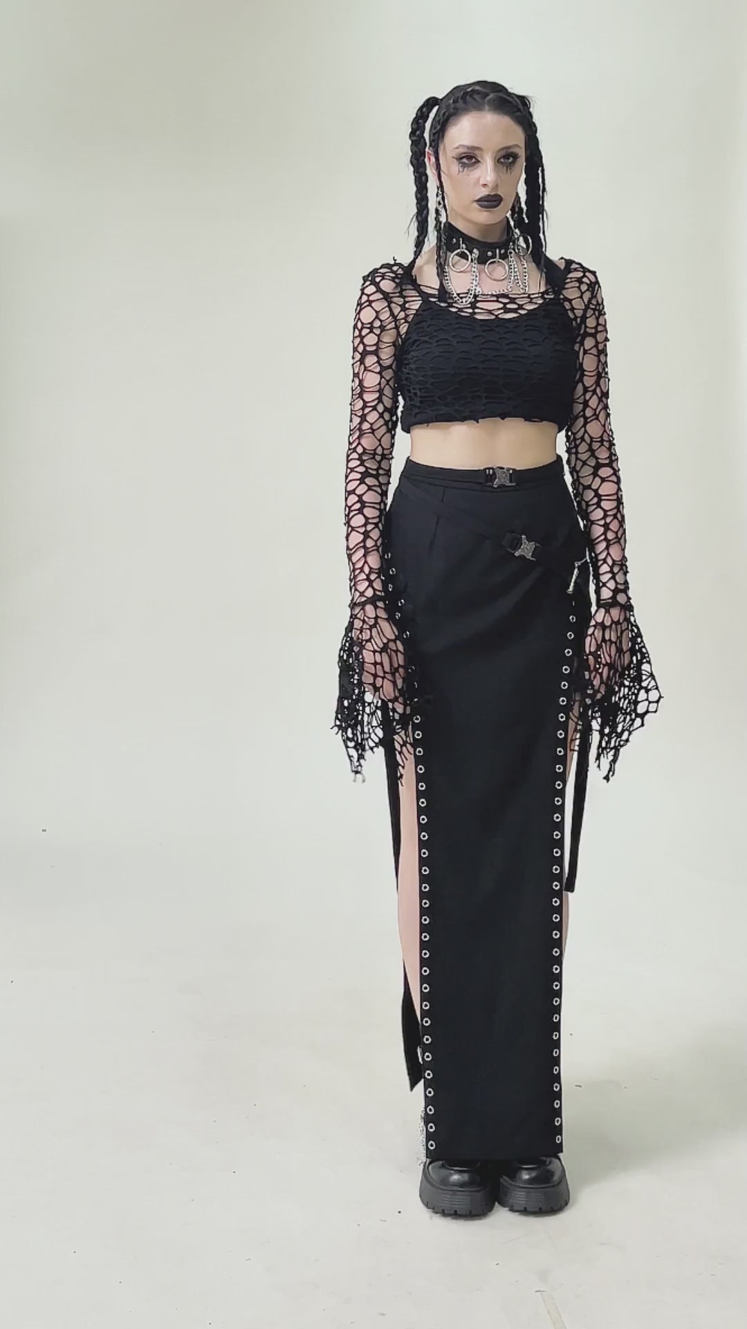 Model wearing a Black Fishnet Mesh Off-Shoulder Gothic Crop Top paired with a long black skirt and edgy accessories.