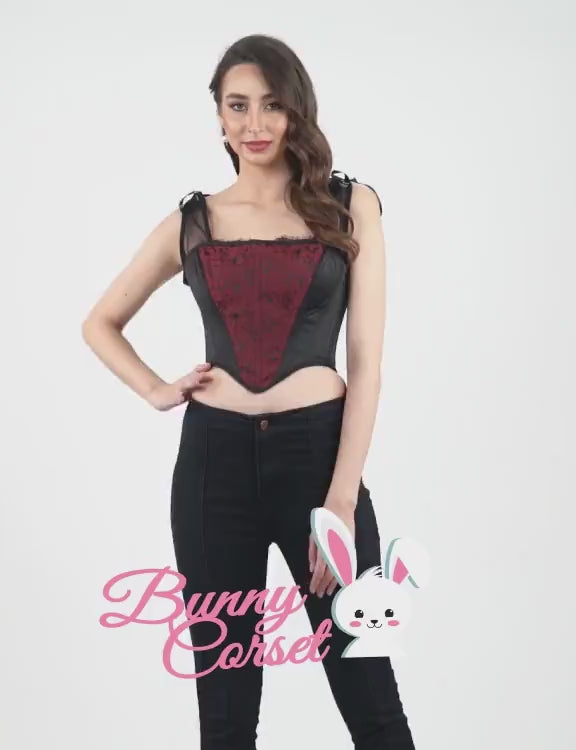 Model wearing a chic lace-up overbust corset with ribbon shoulder ties and black high-waisted jeans.