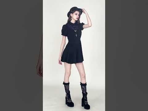 Model wearing a Black Gothic Mini Dress with Purple Lace Yoke and platform boots, showcasing a chic dark academia style.
