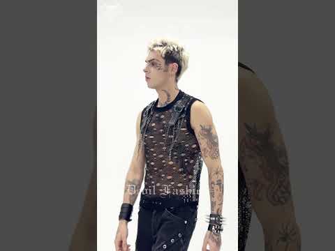 Cyberpunk Distressed Fishnet Top with Buckle Shoulder Straps on model showcasing punk style and edgy accessories.