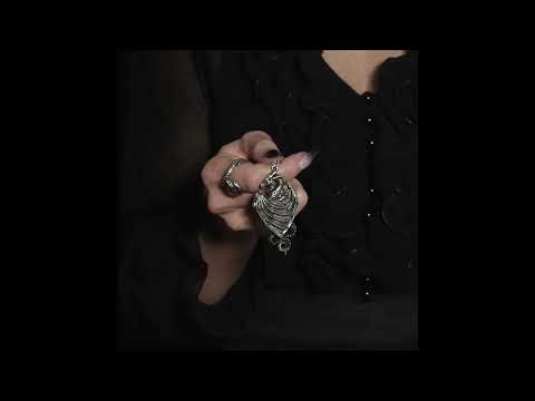 Woman holding the Dragonistii Order Talisman Pendant with Hidden Locket, showcasing its intricate design and gothic style.