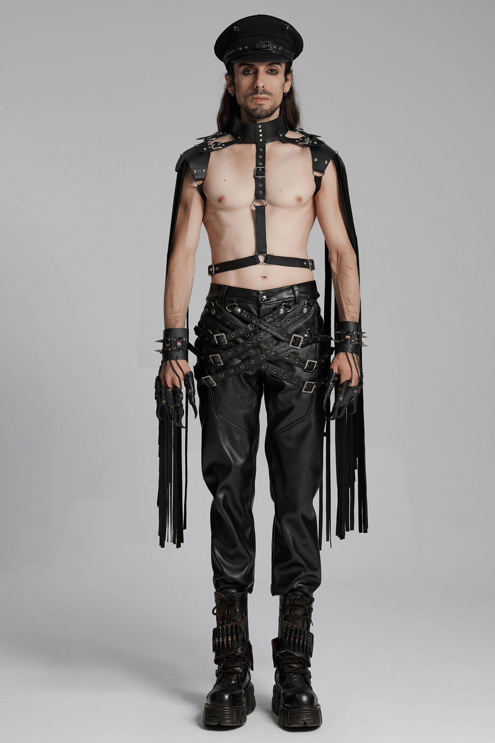 Model showcasing edgy punk outfit with black leather pants, harness, and accessories, perfect for statement streetwear.