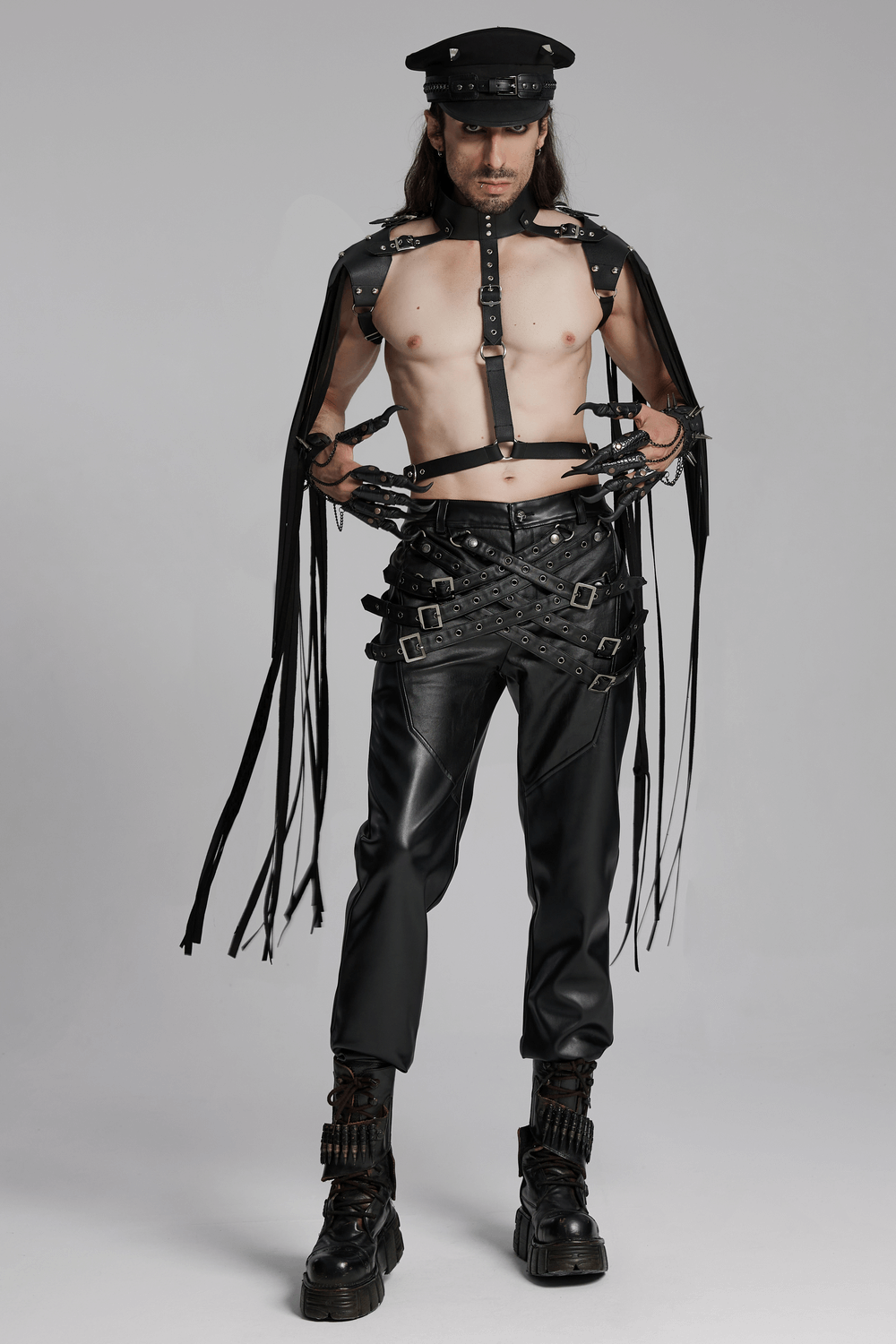 Model showcasing edgy PU leather pants with buckle details, styled with a punk aesthetic and bold accessories.