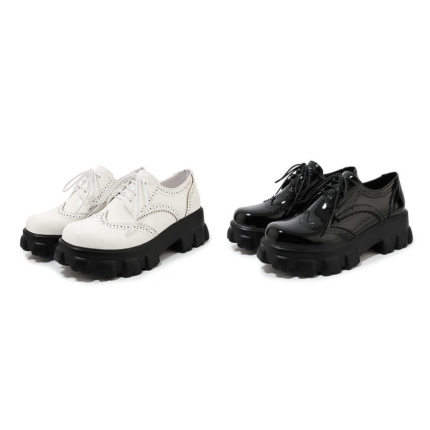 PU patent leather platform women's shoes in black and white with square heel, round toe, and lace detailing.