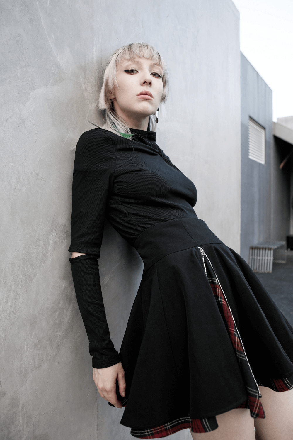 Punk A-Line skirt with red and black plaid detail, featuring side zippers and stylish silhouette, worn by a model.