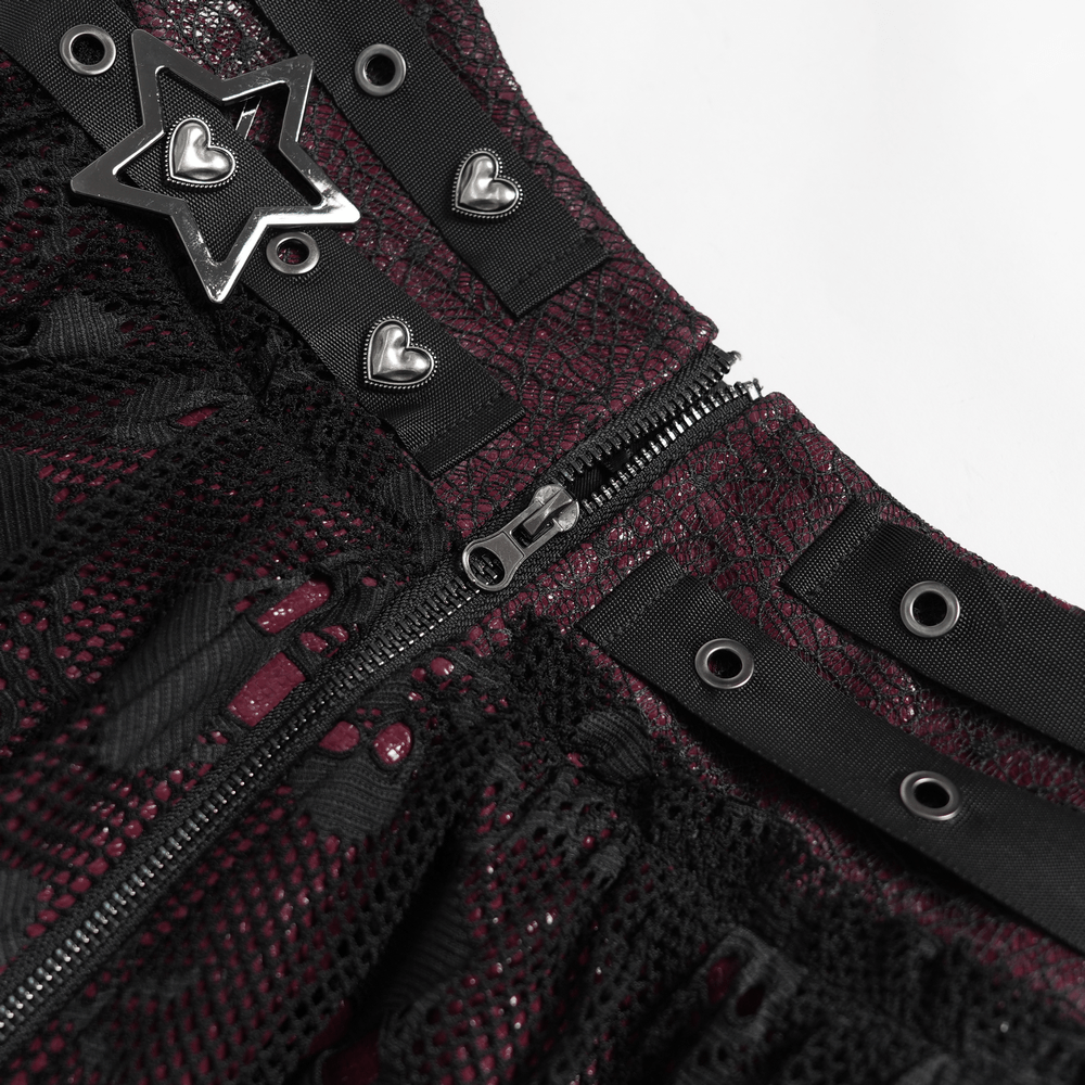 Close-up of Punk Asymmetric Skirt with Belts and Star Buckles showcasing skull mesh, heart studs, and grommet details.