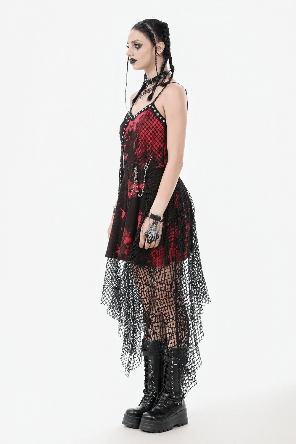 Gothic asymmetrical dress with fishnet skirt and studded chain, perfect for edgy rock fashion.