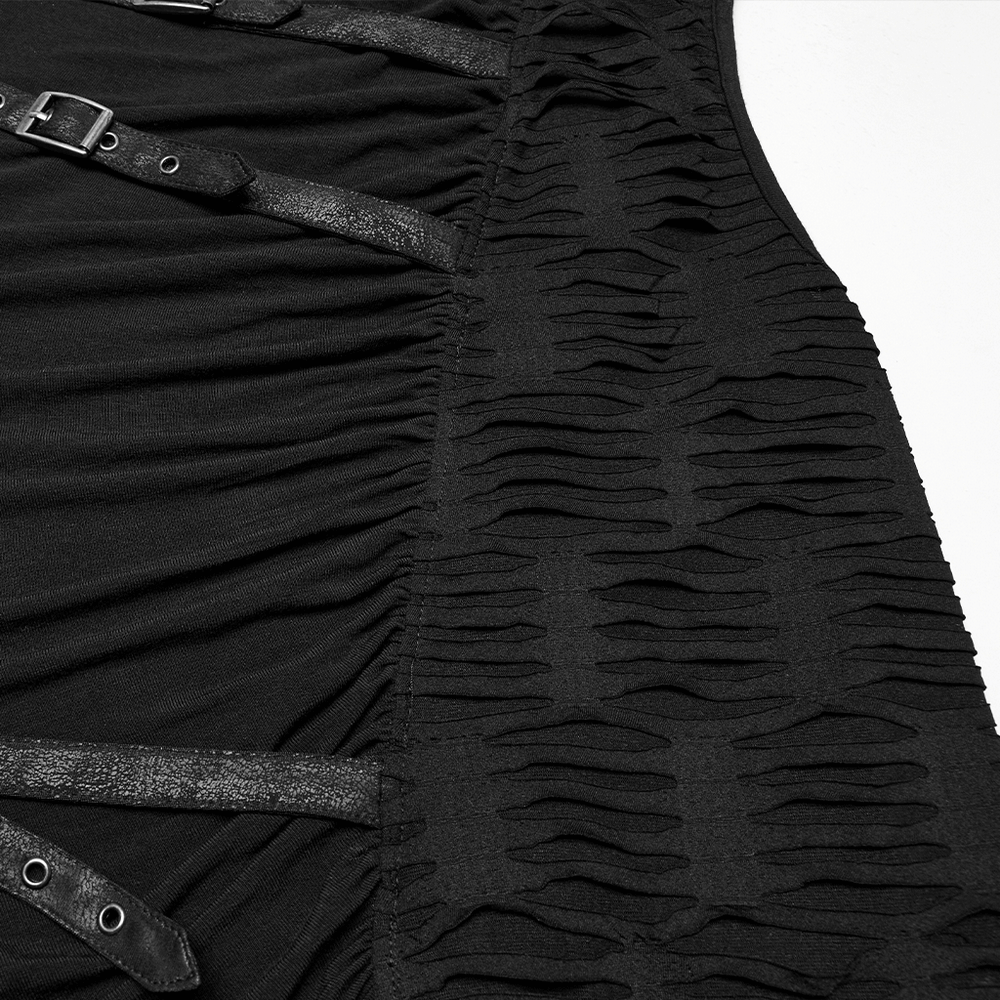 Close-up of punk asymmetrical sleeveless top featuring tattered knitted fabric and riveted straps for edgy streetwear style.