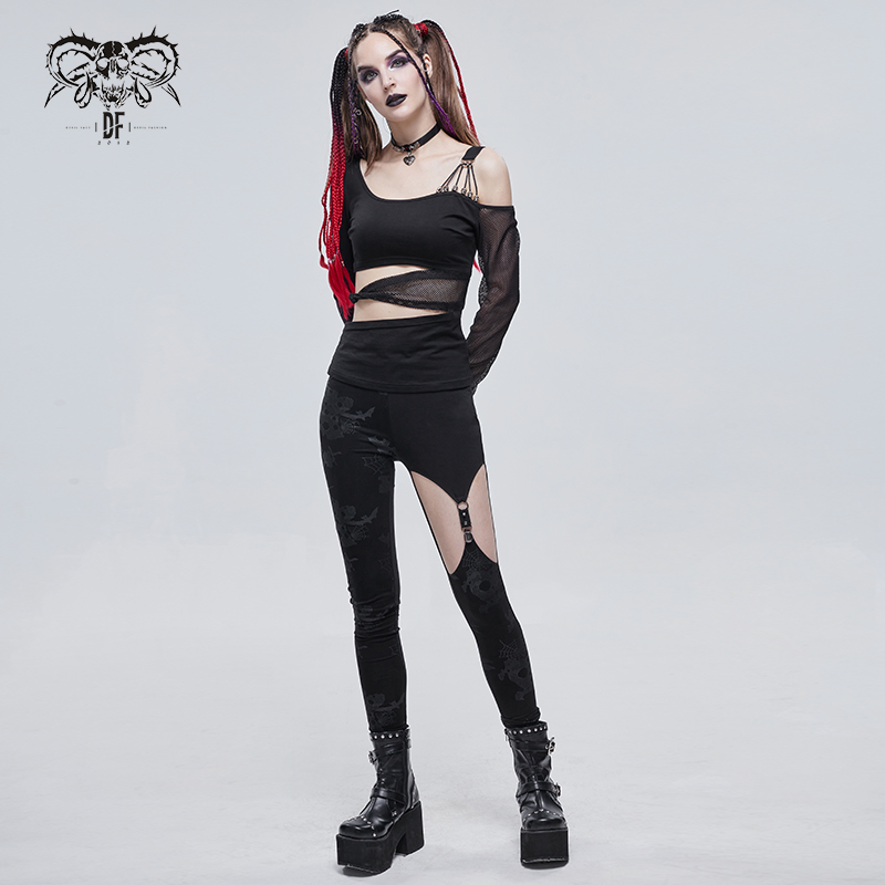 Punk style woman in asymmetrical black leggings and top, showcasing edgy fashion elements and bold makeup.