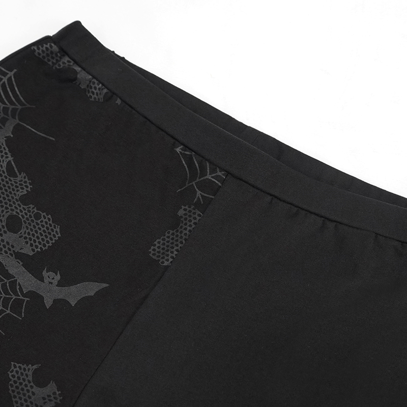 Close-up of punk style women's black leggings with bat and spider web print for a stylish look.