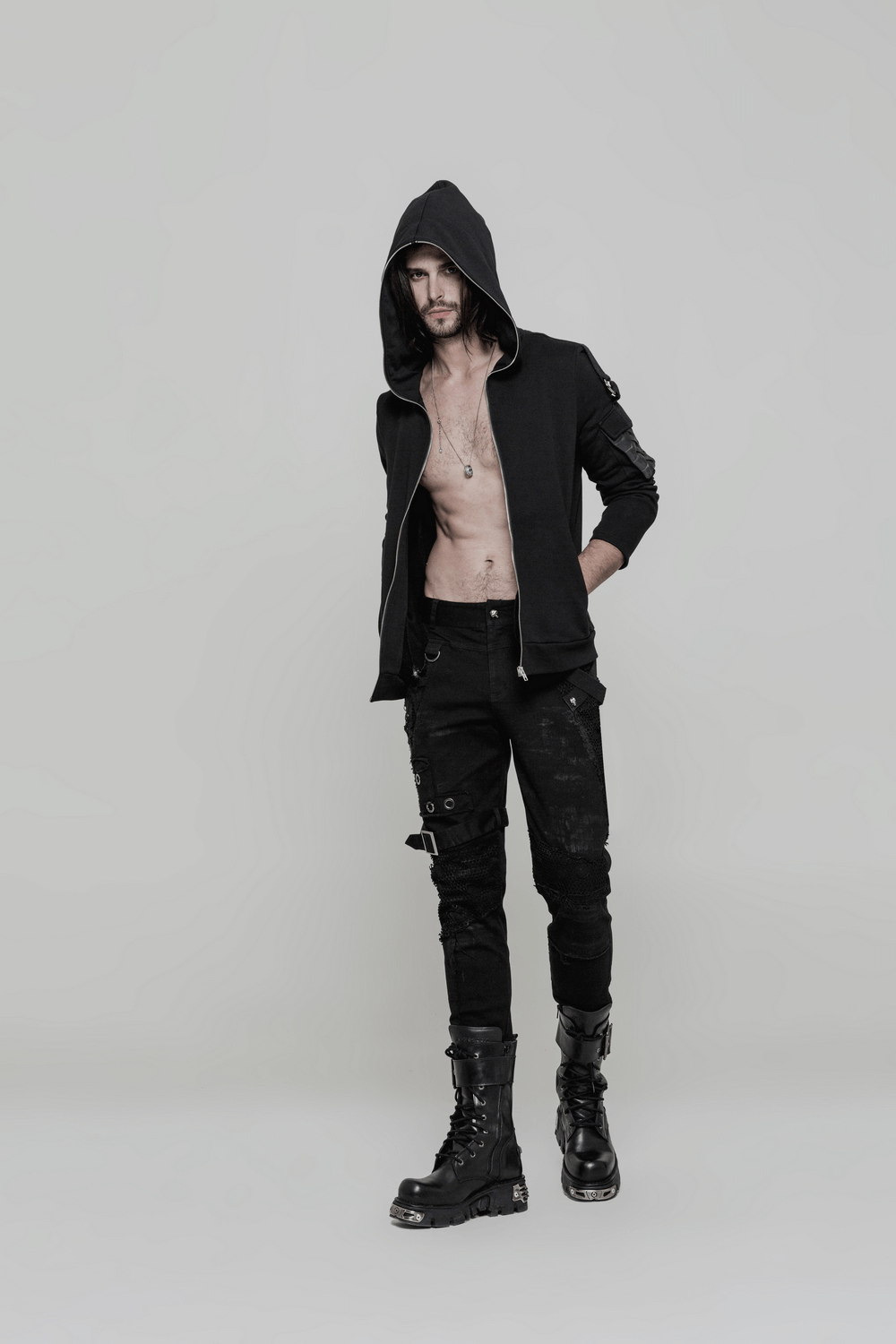 Punk black destroyed jeans with lace and buckle, paired with a stylish black hoodie and edgy combat boots.