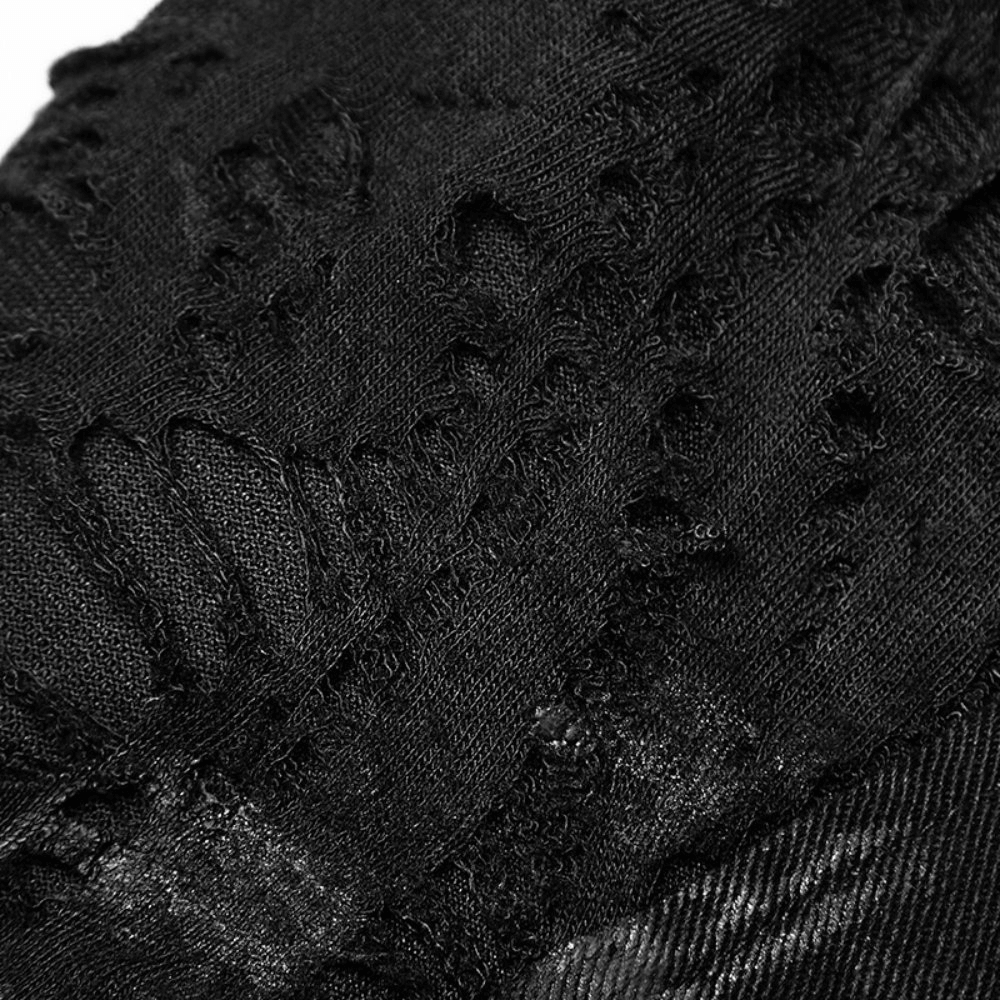 Close-up of punk black destroyed jeans showing ripped details and distressed texture for edgy fashion lovers.