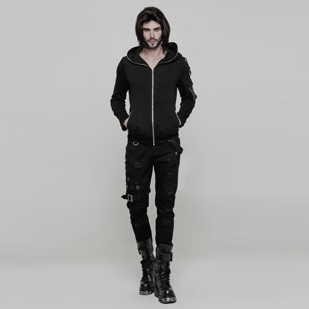 Punk style model wearing black destroyed jeans with lace and buckle, paired with a black zip-up hoodie and boots.