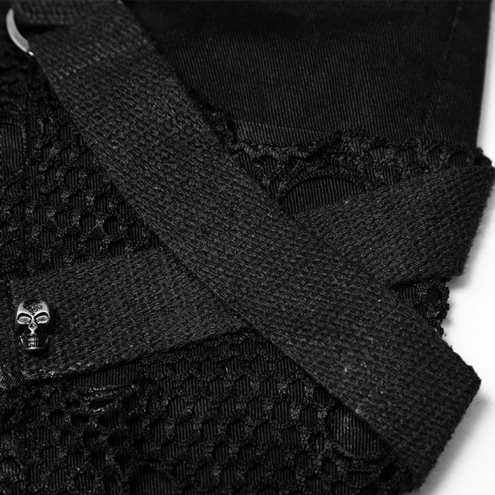 Close-up of black jeans with lace and skull buckle detail, showcasing a punk rock style.