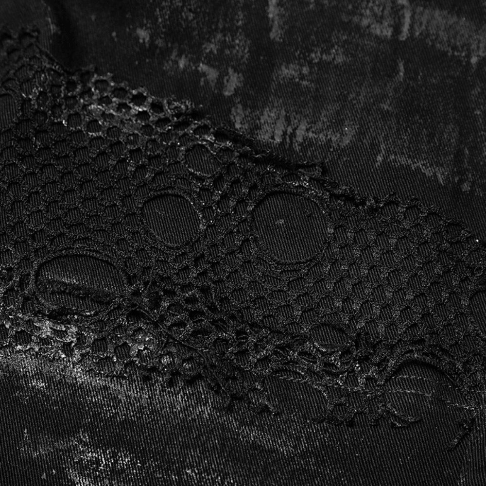Close-up of punk black jeans with ripped mesh detailing, showcasing edgy fashion and vintage style.