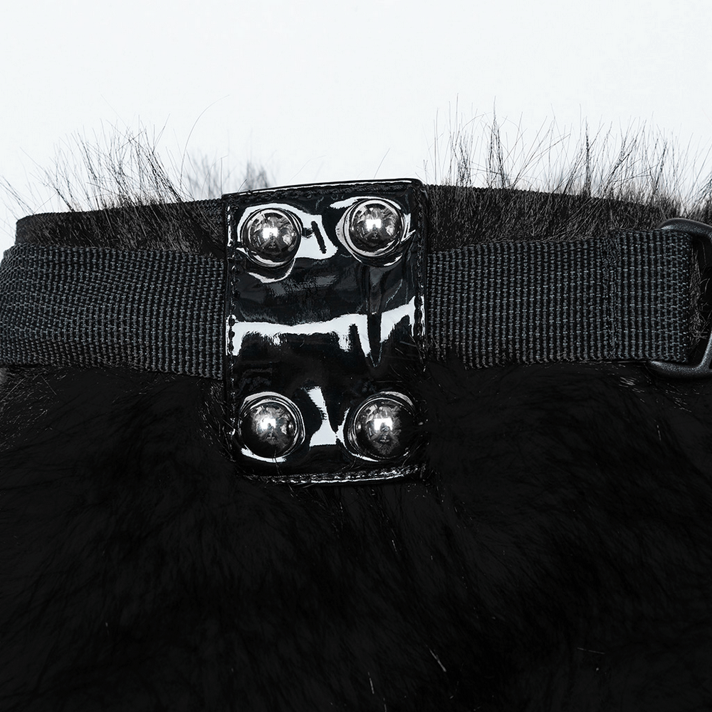 Close-up of punk black faux fur leg warmers featuring shiny patent leather strap and rivets for a stylish, edgy look.