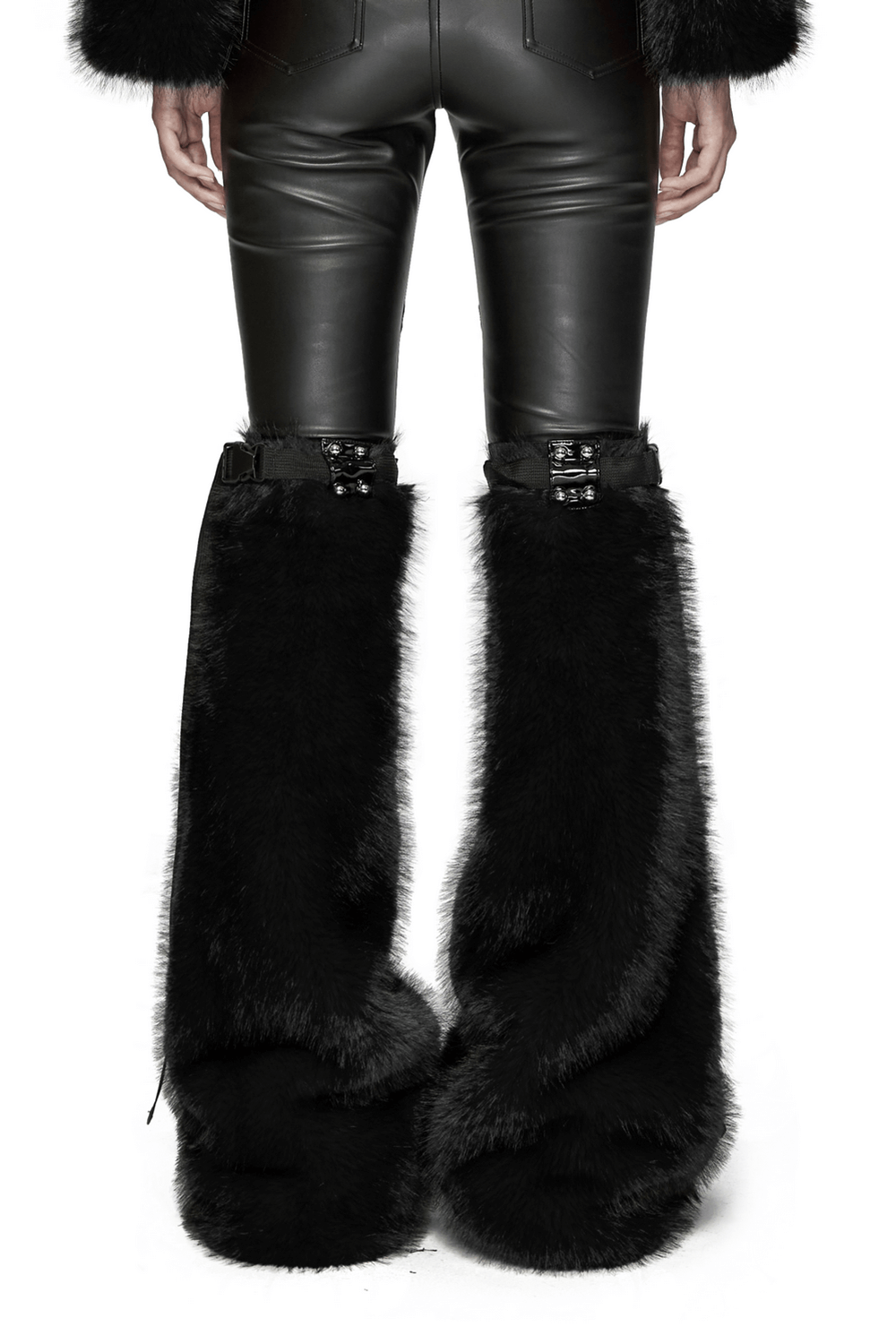 Punk black faux fur leg warmers with rivet details over black leather pants for a trendy, edgy look.