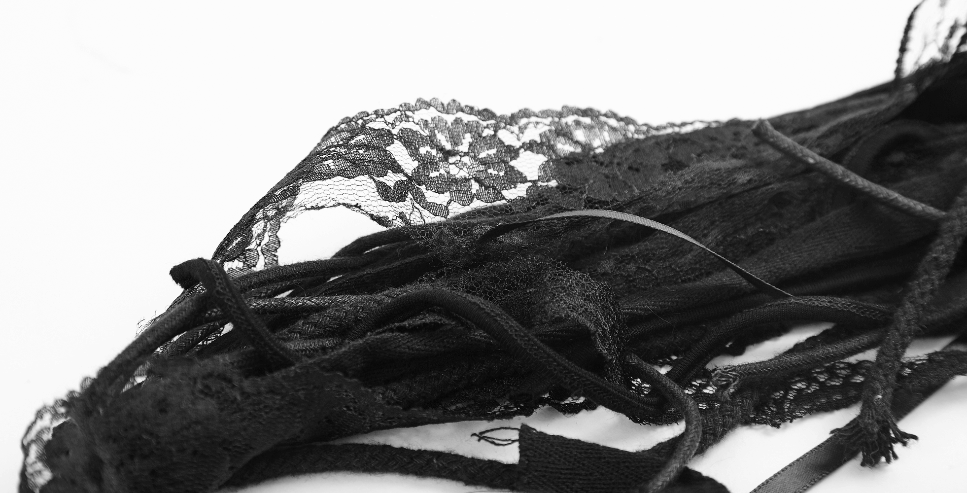 Black lace strips and cords, perfect for punk or gothic accessories and fashion projects.