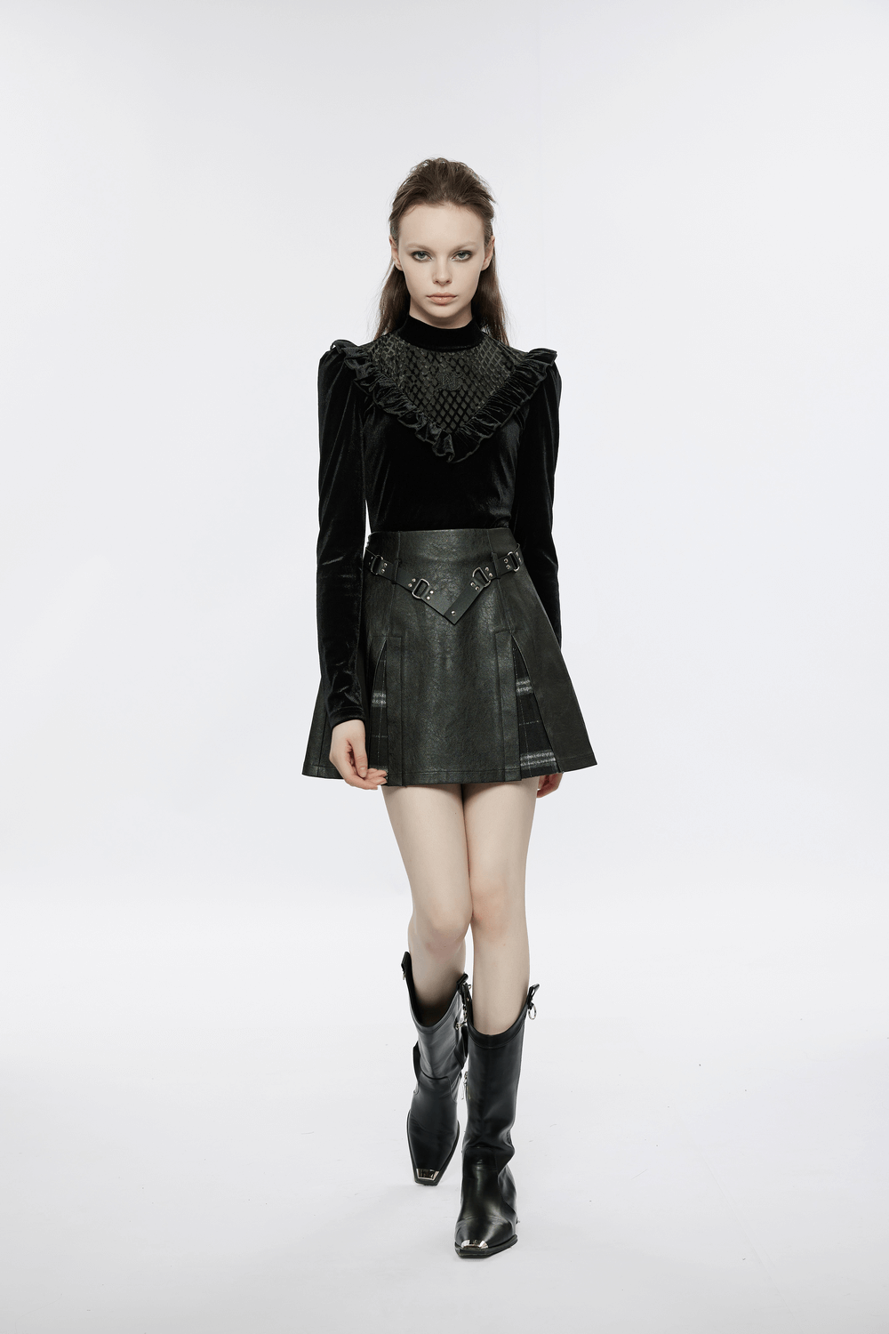Model showcasing punk black faux leather A-line mini skirt with plaid insert and ruffled top, stylish and edgy look.