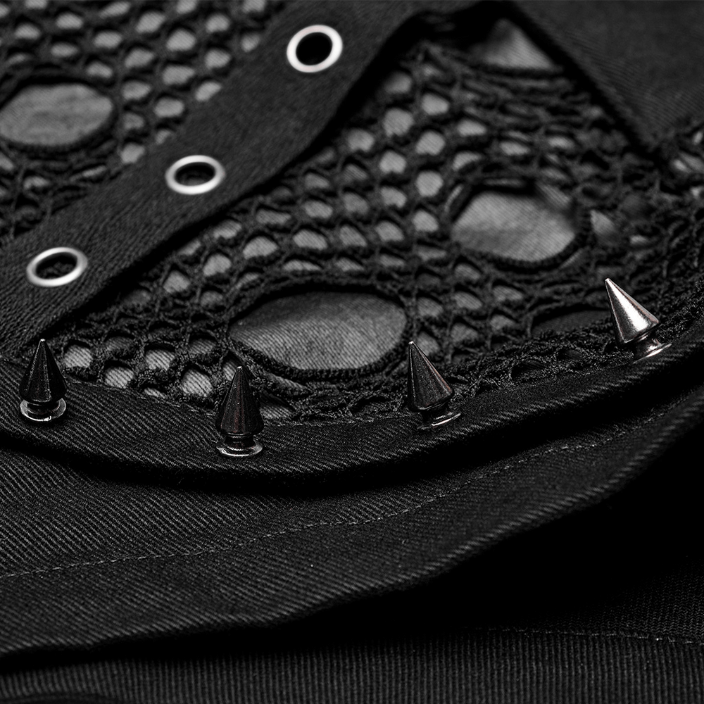 Close-up of punk black mesh fabric with decorative spikes and eyelets, showcasing edgy texture and style.