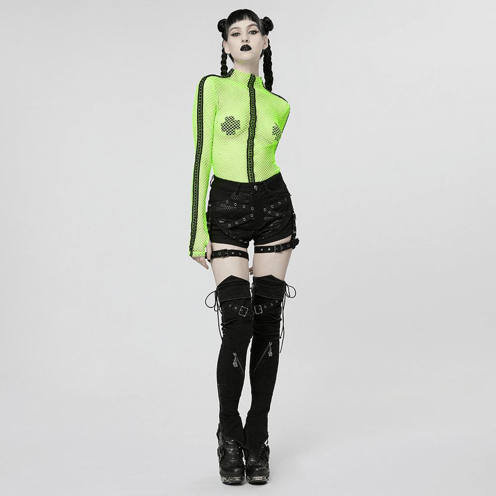 Model wearing punk black mesh garter shorts with buckle straps and a neon green top, showcasing edgy fashion style.