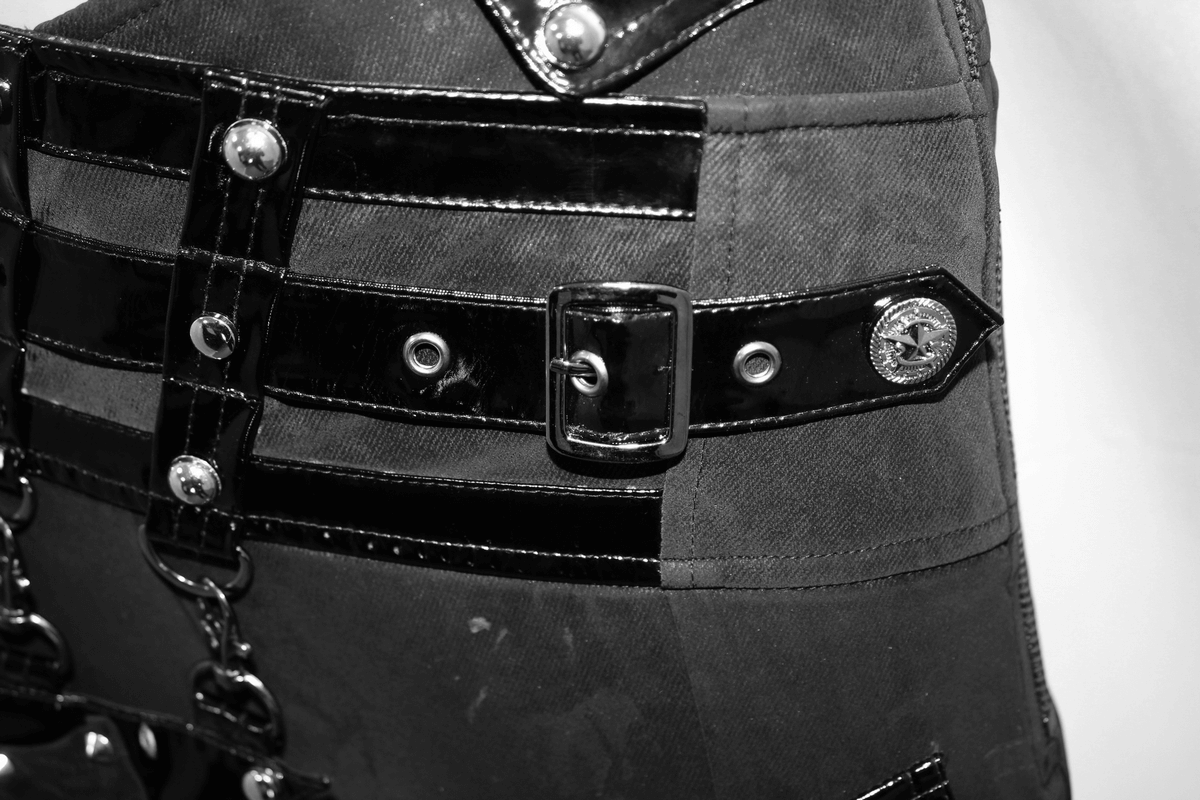 Close-up of punk black pants featuring shiny PU patent leather and silver metal accents, perfect for edgy women's fashion.