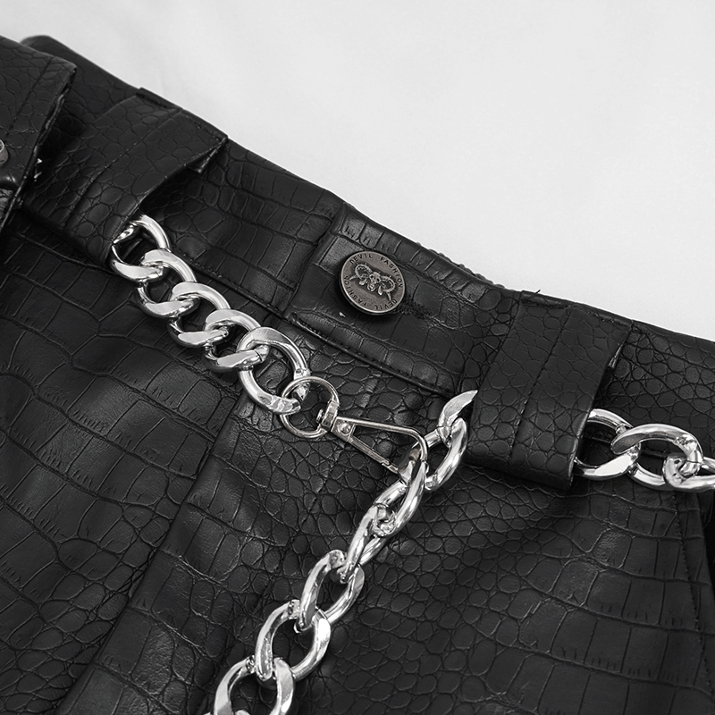 Close-up of punk black PU leather cargo pants with thick silver chain accent and textured finish.