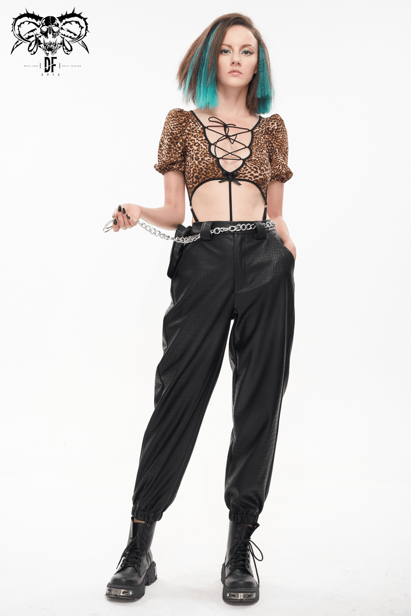 Punk black PU leather cargo pants with metal chain, model showcasing stylish outfit for women in a chic pose.