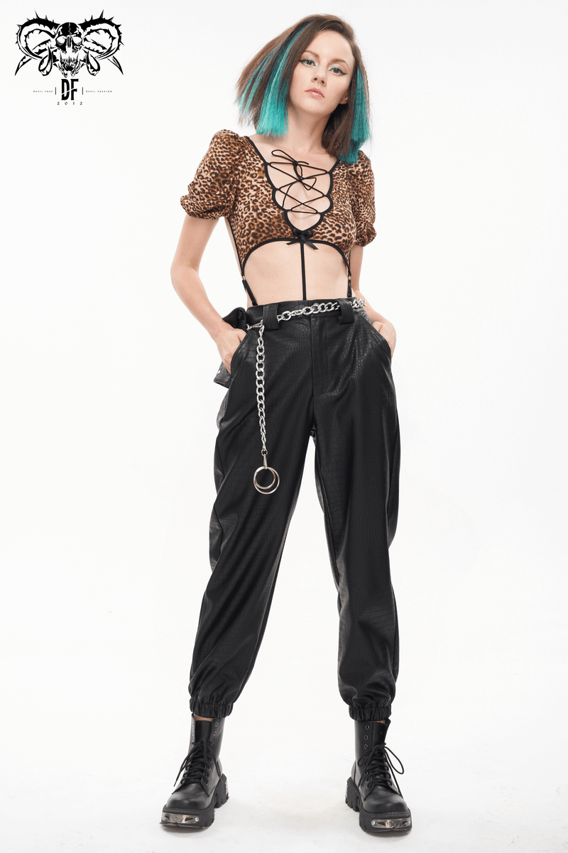 Punk style woman in black PU leather cargo pants, showcasing a thick metal chain and trendy outfit.