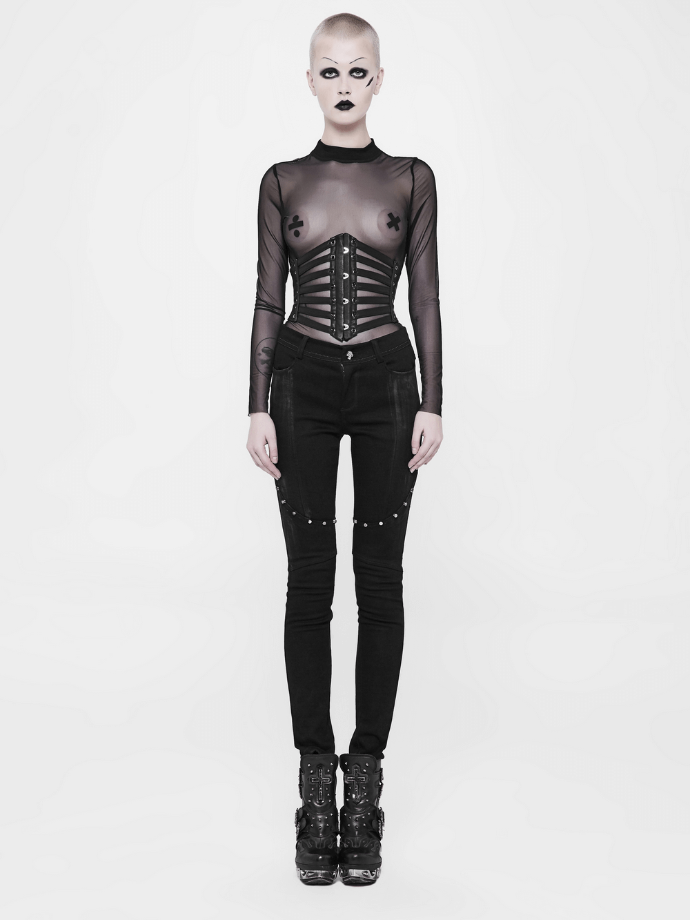 Punk style model in sheer black top with waist girdle and edgy black jeans, showcasing bold fashion statement.