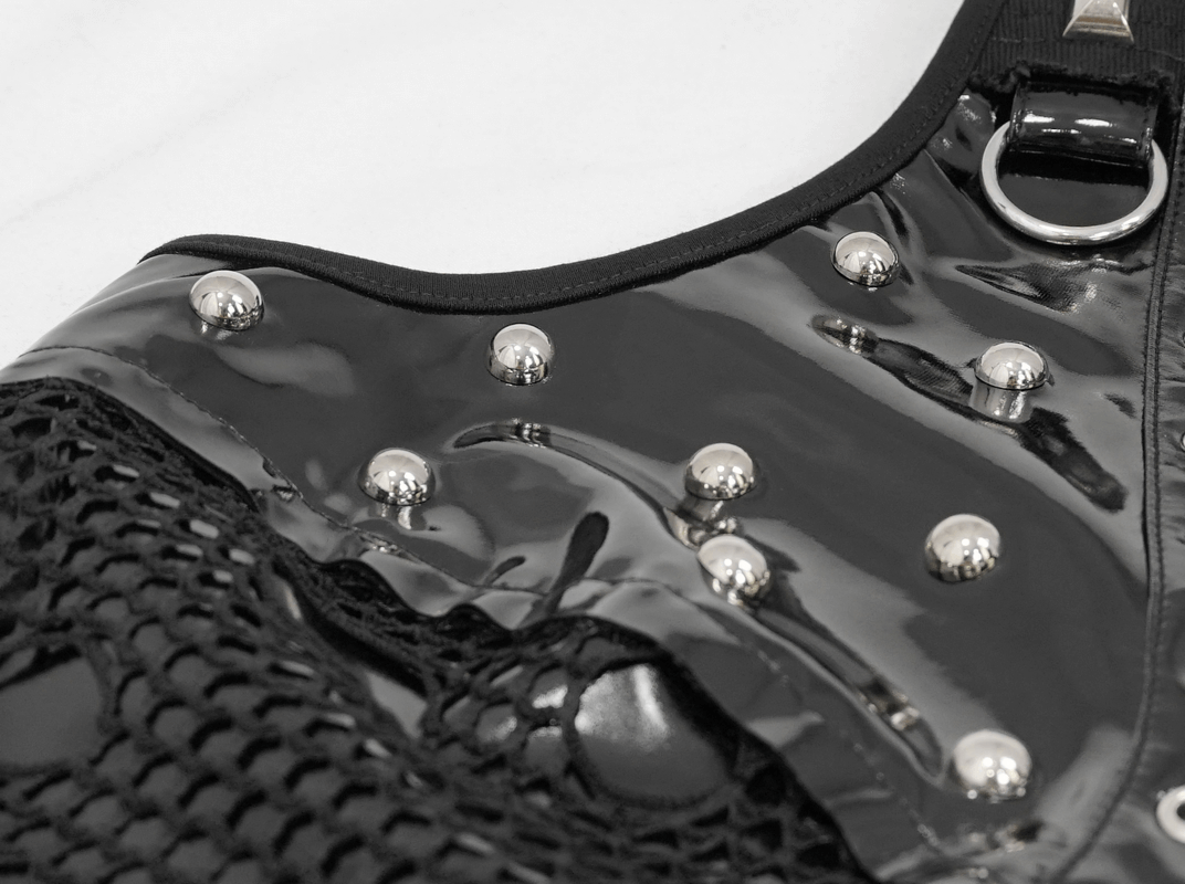 Close-up of black shiny fabric with silver rivets and mesh detailing, perfect for a punk-style women's top.