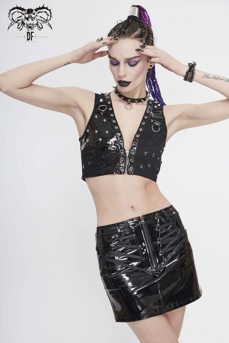 Punk black sleeveless top with mesh and rivets, styled with a shiny black skirt, perfect for a trendy edgy look.