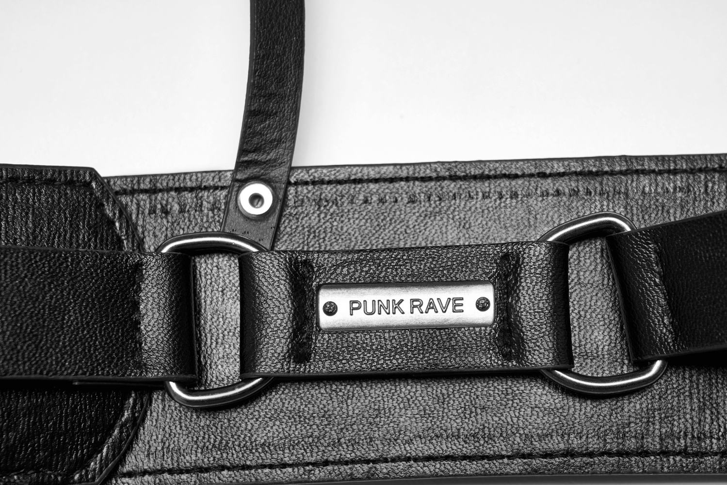 Close-up of Punk Rave black PU leather harness with metal detailing and adjustable straps.