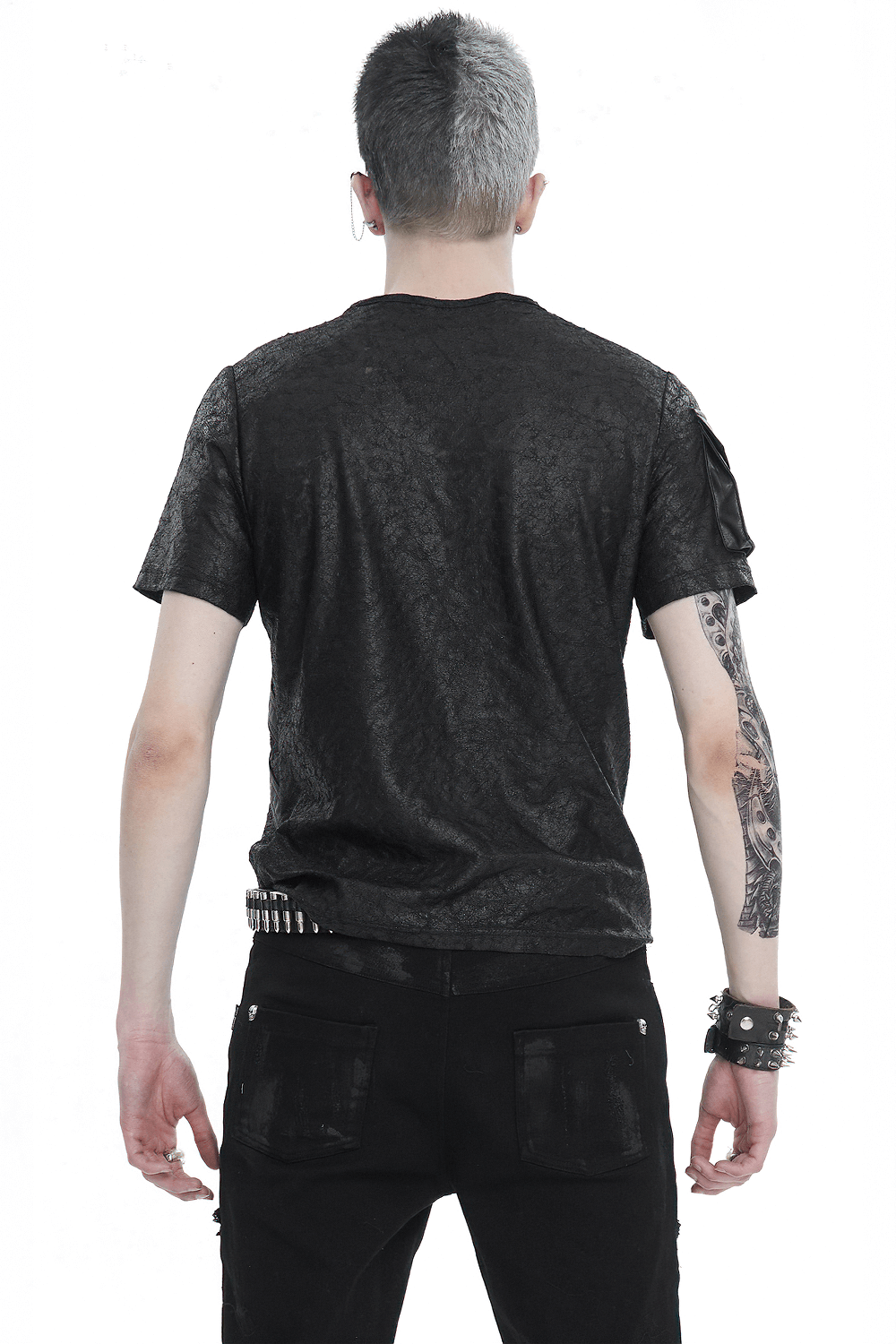 Back view of a man wearing a black punk buckle splice T-shirt, highlighting edgy texture and stylish design.
