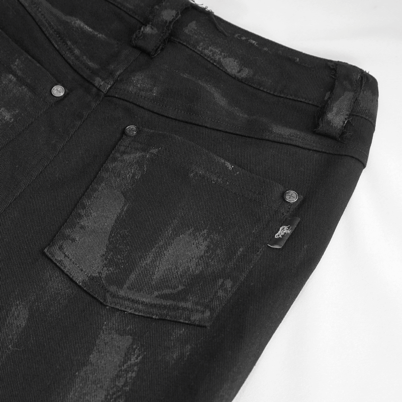 Close-up of punk black trousers showing side pocket and stylish distressed detailing.
