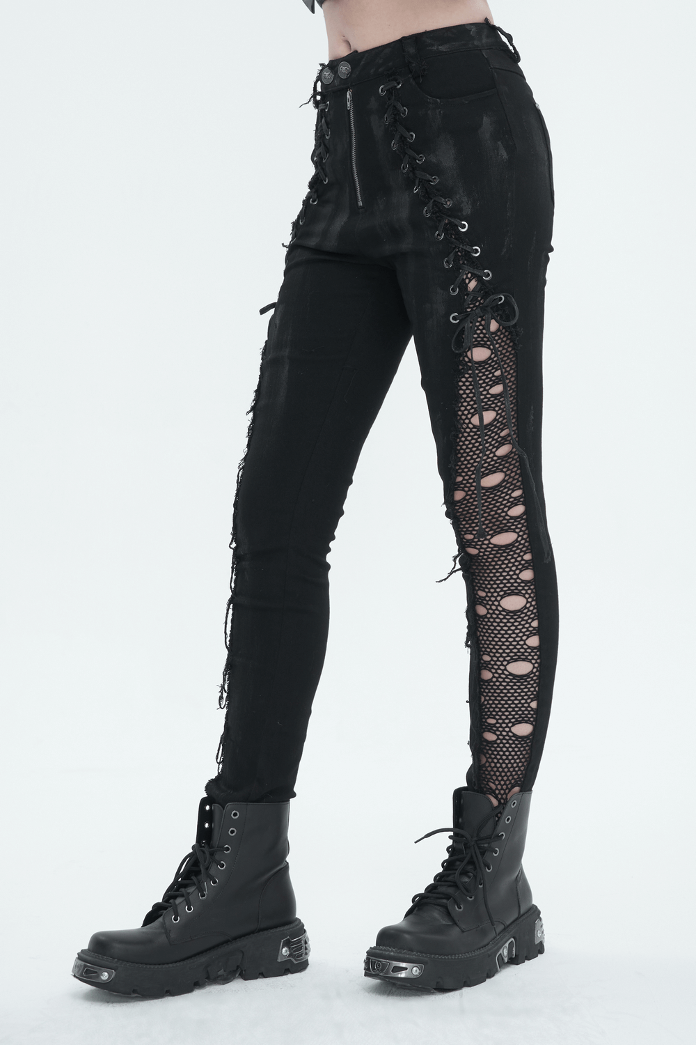 Punk buttoned zip trousers with hole net detailing on sides, worn with black lace-up boots.