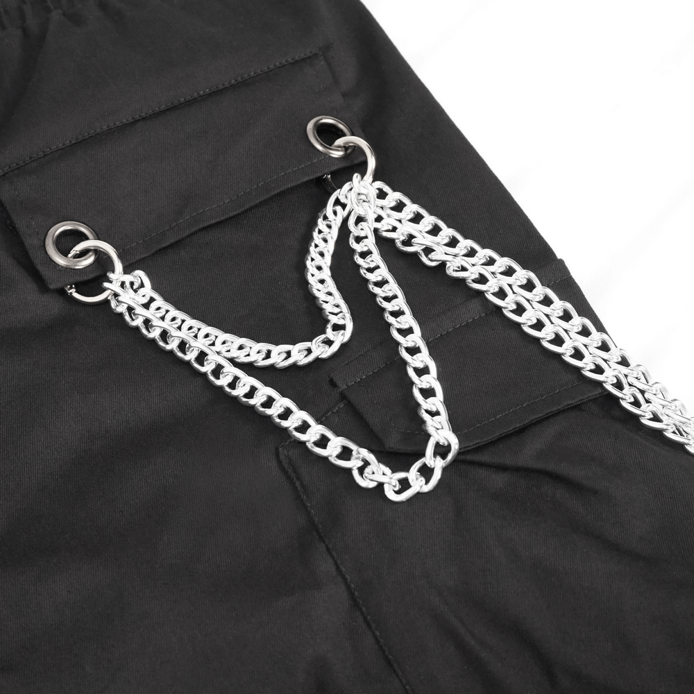 Close-up of black cargo pants featuring silver chain accents and metal rings, showcasing punk and gothic style.