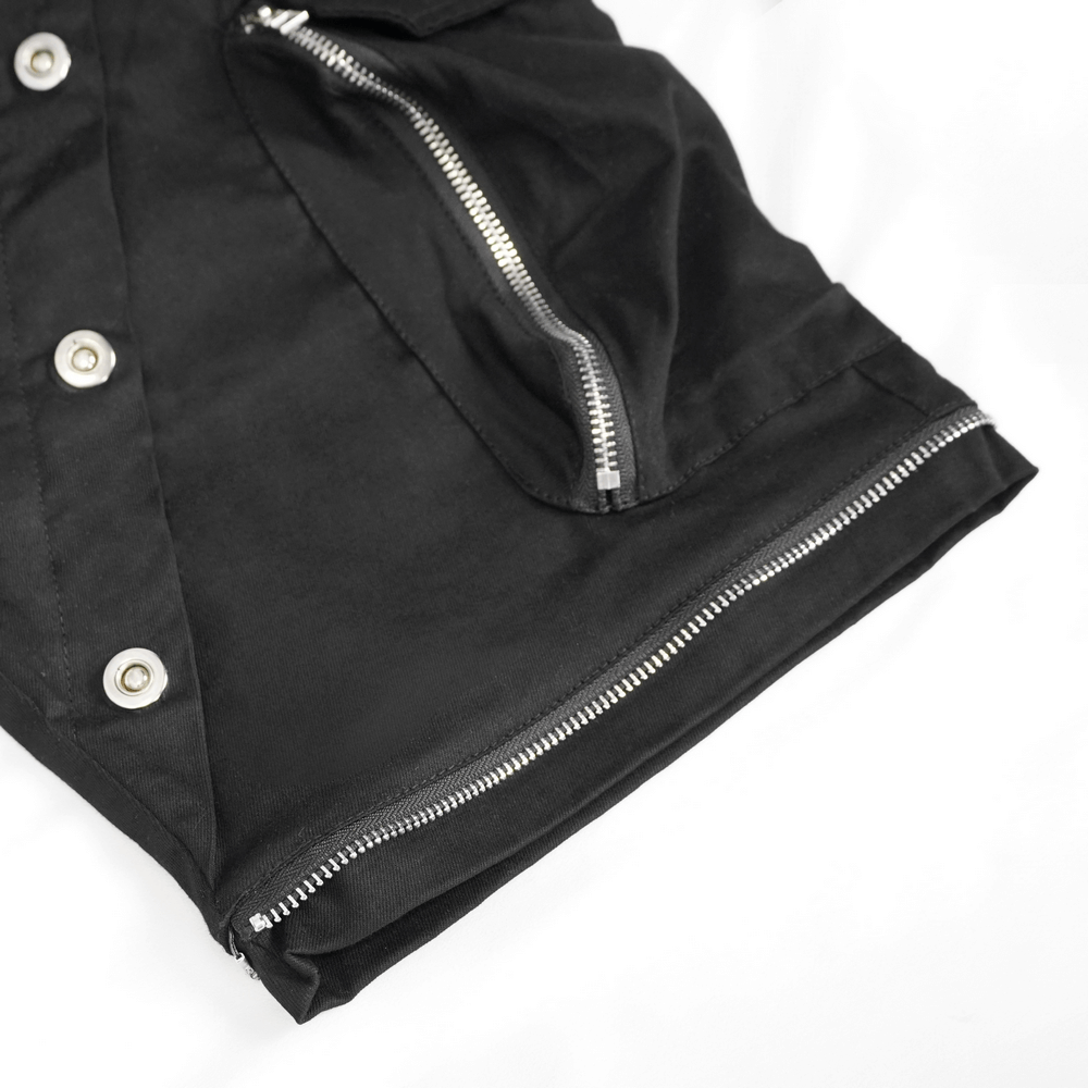 Close-up of black cargo pants featuring metal buttons and stylish zippers for a trendy punk look.