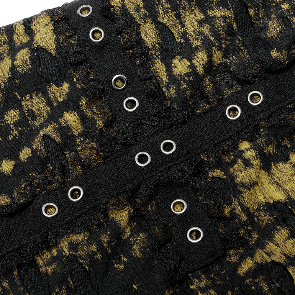 Detailed close-up of the Punk Rave black and yellow knit mini skirt with distressed holes and metal eyelets.