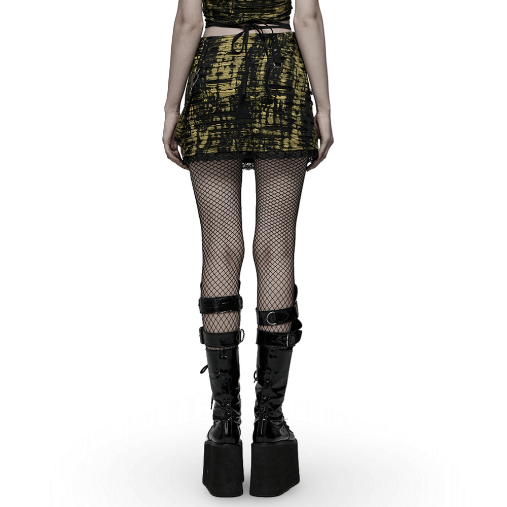 Model showcasing a Punk Cross Dark Decadent knit mini skirt with fishnet tights and platform boots.