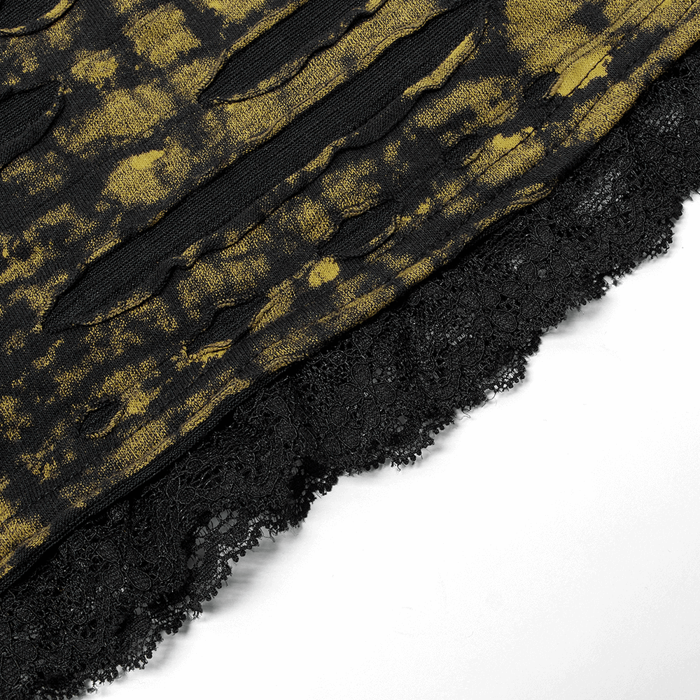 Close-up of dark yellow and black distressed knit mini skirt with ripped detailing and lace trim.