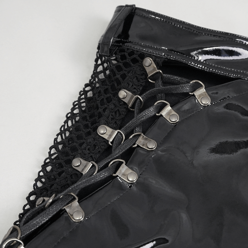 Close-up of punk cut-out patent leather shorts featuring lace-up details and glossy finish.