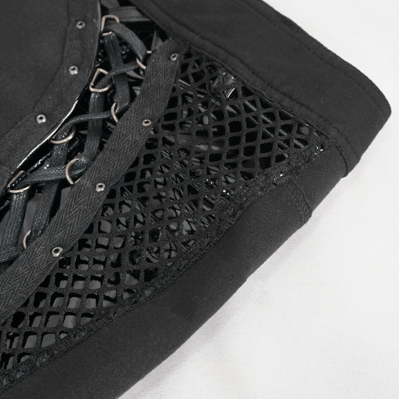 Close-up of punk cut-out patent leather shorts with lace-up detailing and mesh sides, showcasing bold style.