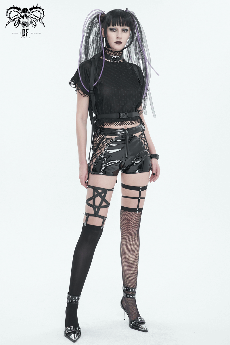 Edgy model in punk cut-out patent leather shorts with lace-up sides and fishnet stockings, showcasing bold style.