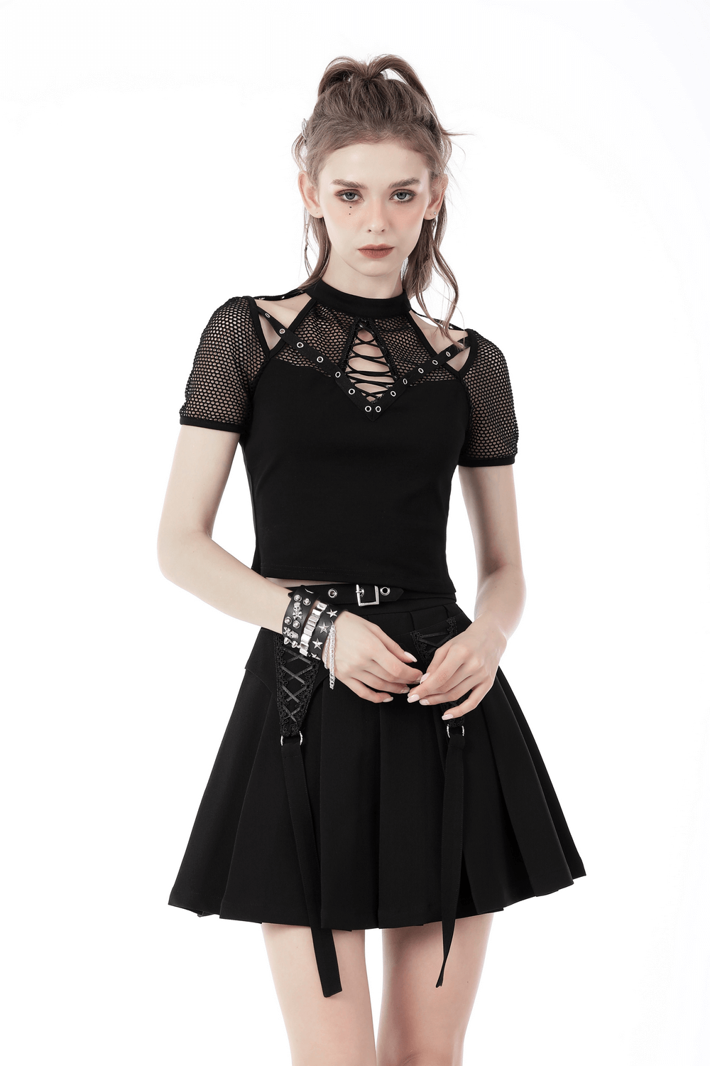Punk cutout T-shirt with mesh sleeves, lace-up front paired with a black skirt for a bold, edgy look.