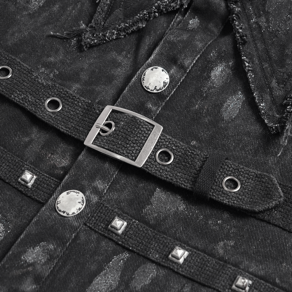 Close-up of punk denim shirt with lace-up sides, studded detail, and unique buckle design.