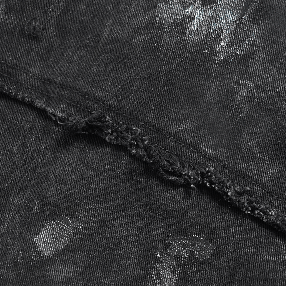 Close-up of punk denim shirt's distressed edge, showcasing lace-up sides and edgy, studded details.