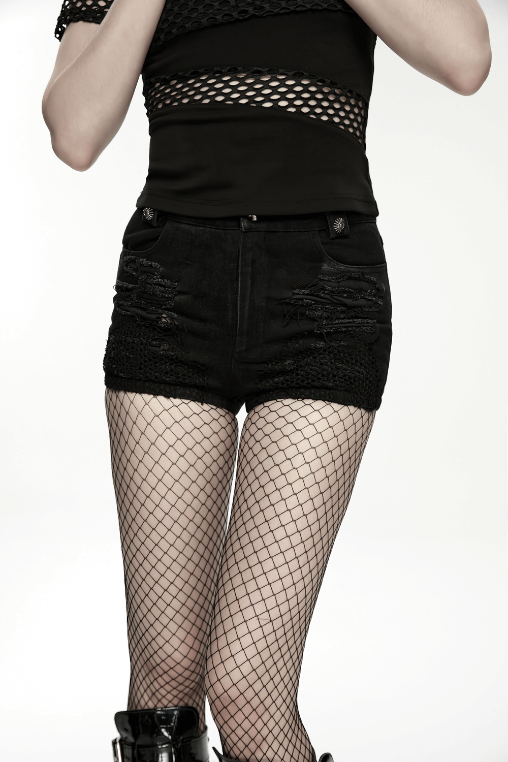 Punk Denim Shorts with Detachable Bag and Leg Strap paired with fishnet stockings for a bold punk look.