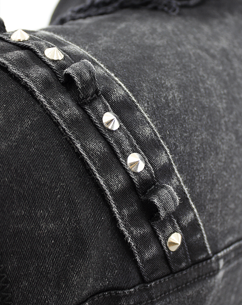 Close-up of black denim vest with silver studs, showcasing punk style design and quality craftsmanship.